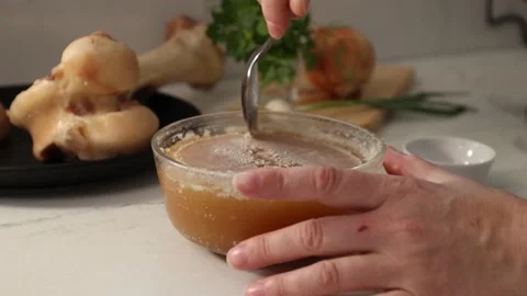 Dense, gelatinous bone broth cooled to showcase collagen-rich texture and Stock Footage 344031627