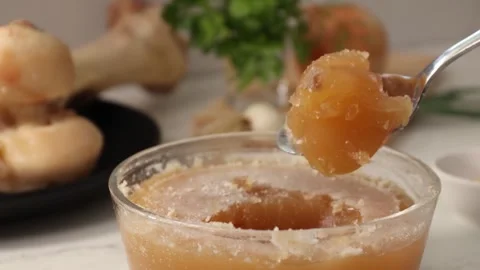 Dense, gelatinous bone broth jelly in a glass jar; collagen-rich, anti-aging Stock Footage 344031604
