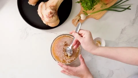 Dense Gelled Bone Broth with High Collagen: Cold, Viscous Texture Demonstration Stock Footage 344032163