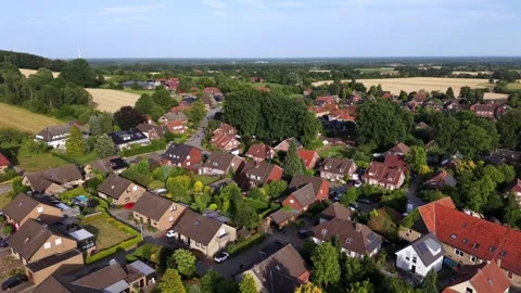Dense German suburb spreads beneath bright summer sun, red-tiled rooftops and Stock Footage 340540929