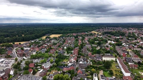 Dense German town spreads beneath heavy storm clouds, red-tiled rooftops and Stock Footage 340405115