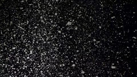 A dense heavy blizzard snowstorm VFX insert in slow-motion on black screen. Stock Footage 301896653