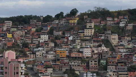 Dense Hillside Housing and Pink Residential Tower Under Cloudy Sky Vídeos de archivo 341668765