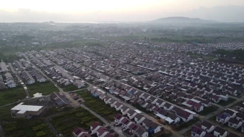 Dense housing neatly arranged with the texture of rice fields with a sunris.. Stock Footage 285410836