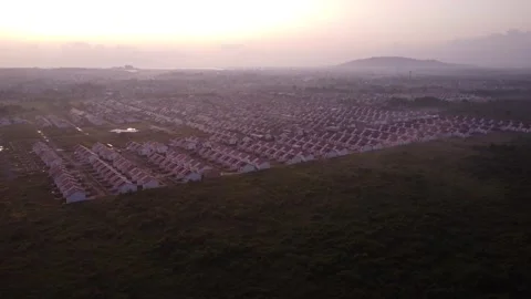 Dense housing neatly arranged with the texture of rice fields with a sunris.. Stock Footage 285414457