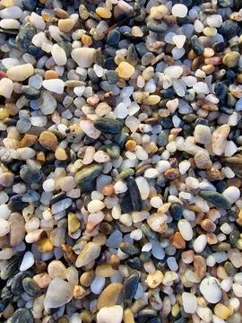 Dense layer of small multicolored pebbles and water worn stones creating un.. Stock Photos