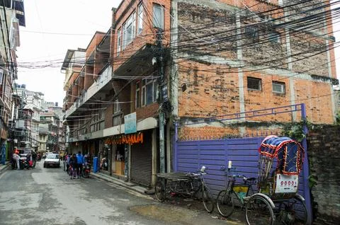 A dense network of wires against the backdrop of a residential building. Stock Photos