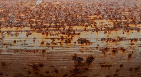 Dense orange rust on weathered metal Stock Photos