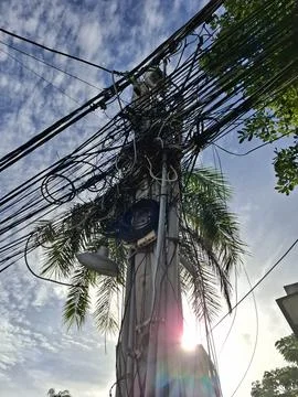 Dense Overhead Power And Internet Cables On Street Pole In Vietnam Stock Photos