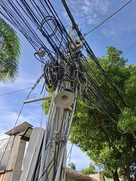 Dense Overhead Power And Internet Cables On Street Pole In Vietnam Stock Photos