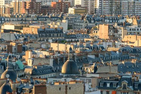 Dense Paris rooftops with domes and chimneys Stock Photos