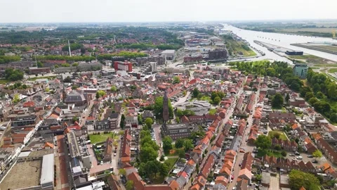 Dense patchwork red tiled roofs historic brick buildings sits along curve Stock Footage 327654253