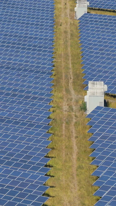 Dense Photovoltaic Array Divided By A Dirt Access Road And Large Storage Ba.. Video stock 338992108