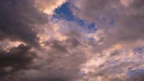 Dense pink cumulus clouds floating along the blue evening sky Stock Footage 137932599