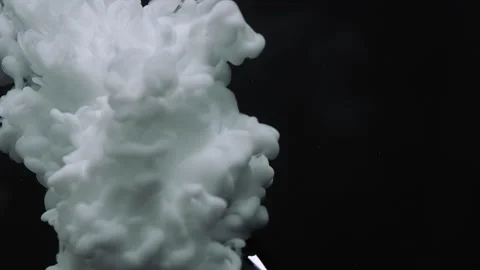 Dense puffs of thick white smoke fall down along the cover on a black background Stock Footage 268492832