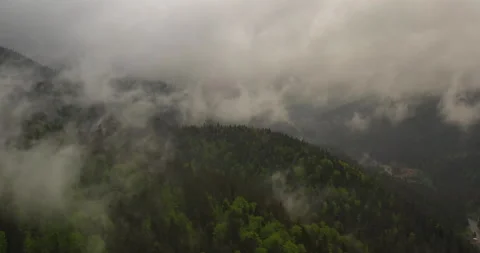 Dense rainy clouds gathering above mountains. Aerial view of wet misty mountain Video stock 156972202