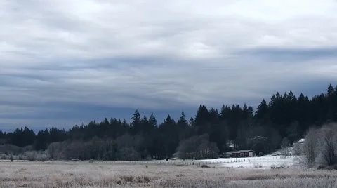 Dense Rolling Winter Clouds Billow Above a Frozen Field Stock Footage 62577644