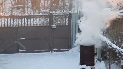 Dense smoke from burning garbage in an iron barrel Stock Footage 167448971
