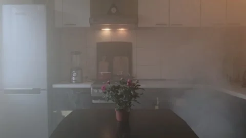 Dense smoke spreads through a kitchen, creating a hazardous atmosphere, while a Stock Footage 306049175