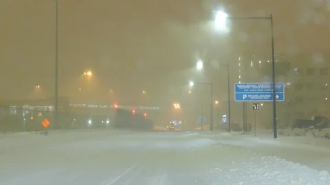 Dense snow creates low visibility in the vicinity of Montreal Airport in Canada Stock Footage 103698933
