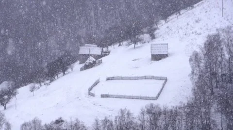 Dense snowfall over the heights with abandoned houses at the edge of dense 714 Stock Footage 58908539