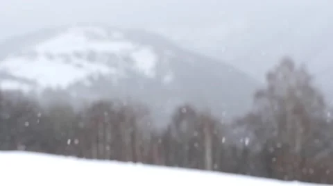 Dense snowfall over the mountains with dense forests of deciduous 709 Video stock 58908879