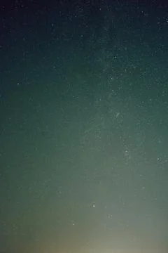 Dense starfield across deep blue night sky with countless tiny lights scattered Stock Photos