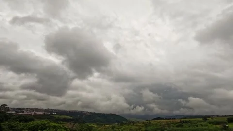 Dense storm clouds moving quickly over an urban landscape Stock Footage 332128248