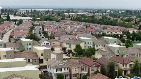 Dense suburban housing with tile and flat rooftops, stucco walls and scattered Stock Footage 337053018
