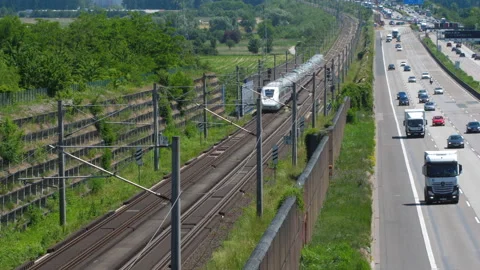 Dense traffic on autobahn A3 and passing ICE highspeed train Stock Footage 155652177