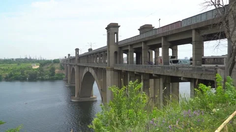 Dense traffic on the bridge over the river Stock Footage 169361270
