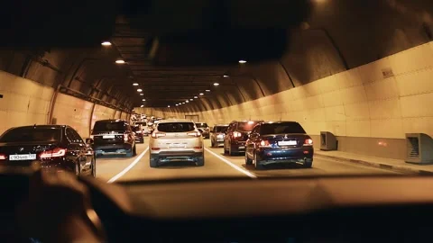 A dense traffic flow is moving through the tunnel. Traffic during rush hour Stock Footage 242789877