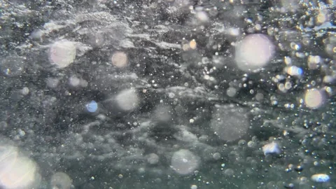 Dense underwater air bubbles fill the scene creating abstract movement below the Stock Footage 344943068