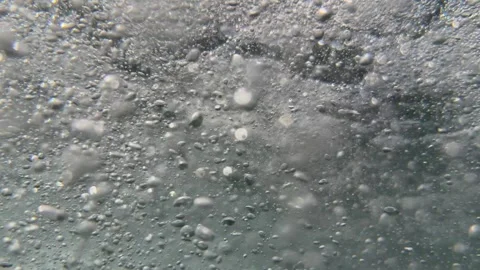Dense underwater air bubbles move through flowing seawater creating natural move Stock Footage 345700447