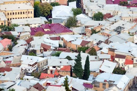 Dense urban development - a view of the roofs of houses from above. Stock Photos