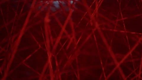A dense web of crimson threads intertwines, forming a mesmerizing pattern. The r Stock Footage 304358344