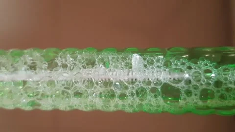 Dense White Air Bubbles Moving Slowly Through Liquid Stock Footage 343941842