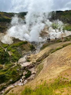 A dense white cloud has descended into a gorge in the mountains Stock Photos