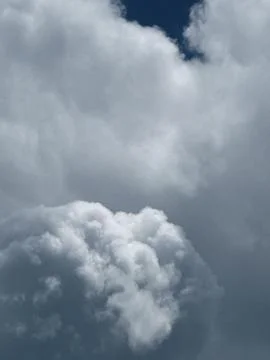 Dense White Gray Cloud Mass Against Blue Sky Фото