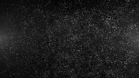 Dense white particles falling on a dark background creating a snow or dust ef Video stock 331996842