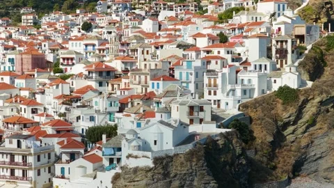 The densely packed whitewashed houses with red-tiled roofs perched on the rocky Stock Footage 346690071