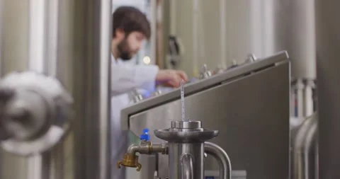 Density measurement of beer. Brewer testing beer at brewery factory. Slow motion Stock Footage 148230692