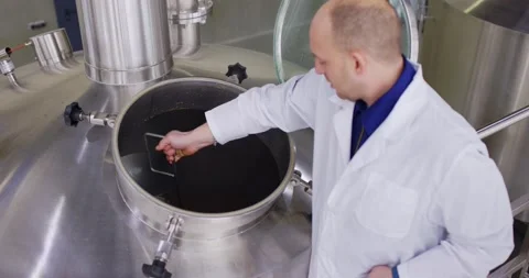 Density measurement of beer. Brewer testing beer at brewery factory. Slow motion Stock Footage 148231037