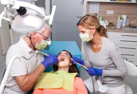 Denstist and his assistant while treatment of female patient with tooth ache Stock-Fotos
