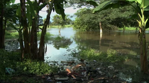 DENSU RIVER PAN: TRASH IN FOREGROUND Stock Footage 58106591