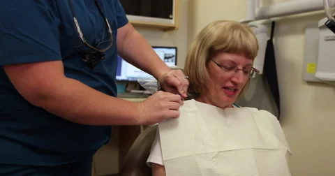 Dental Attach Bib to Patient Stock Footage 57753475