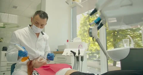 Dental curing light used for teeth treatment, modern equipment, process Stock Footage 137118187