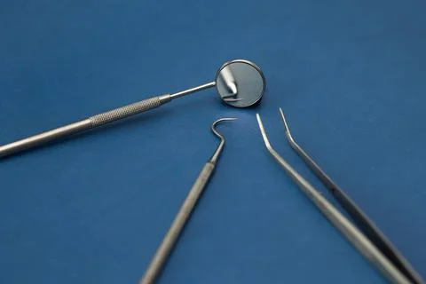 Dental examination instruments on blue background with copy space Stock Photos