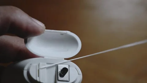 Dental floss container opening pulling and cutting thread close-up Stock Footage 345506336