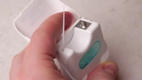 Dental floss pulling from container in slow motion Stock Footage 306192842